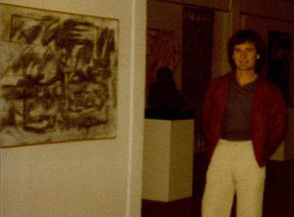 Ron Marlett standing near his abstract painting.