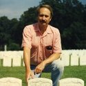 Ron Marlett's older brother Rob sits near a relative's grave.