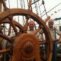 Ron Marlett and his friend John Mack at the HMS Surprise's wheel.