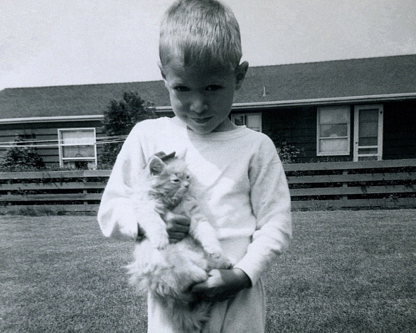 Ron Marlett holding the family cat.