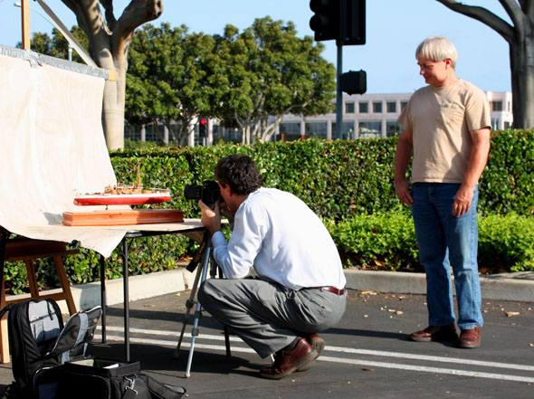 Anthony Mack photographing Ron Marlett's model ship.