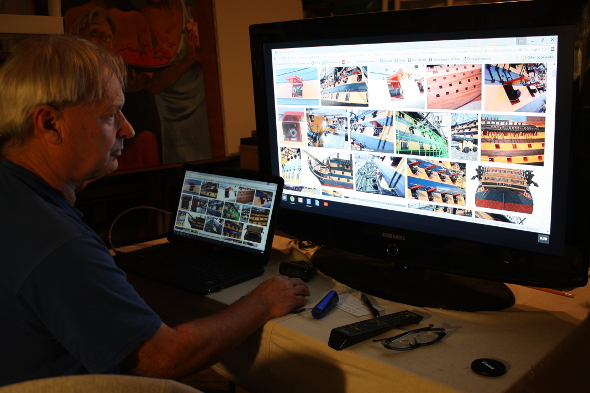 Ron Marlett studying HMS Victory on the internet.