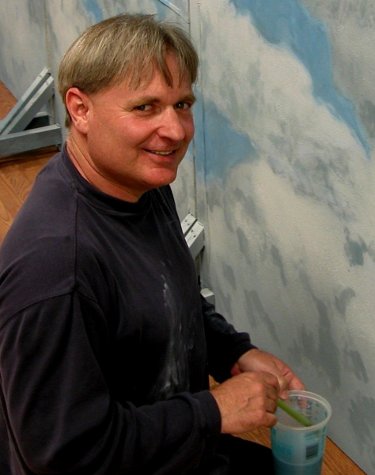 Ron Marlett working on a backdrop for Aniar dance studio.